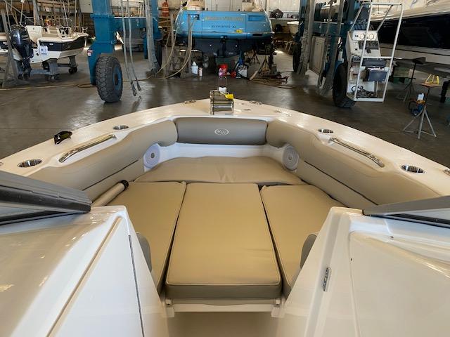 Slide: The Image of 2024 Key West 239 DFS boat interior with cushioned seating in a workshop. - 7