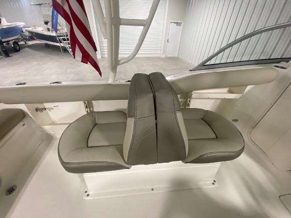 Slide: The Image of 2024 Key West 239 DFS boat with dual seats and American flag in a showroom. - 8