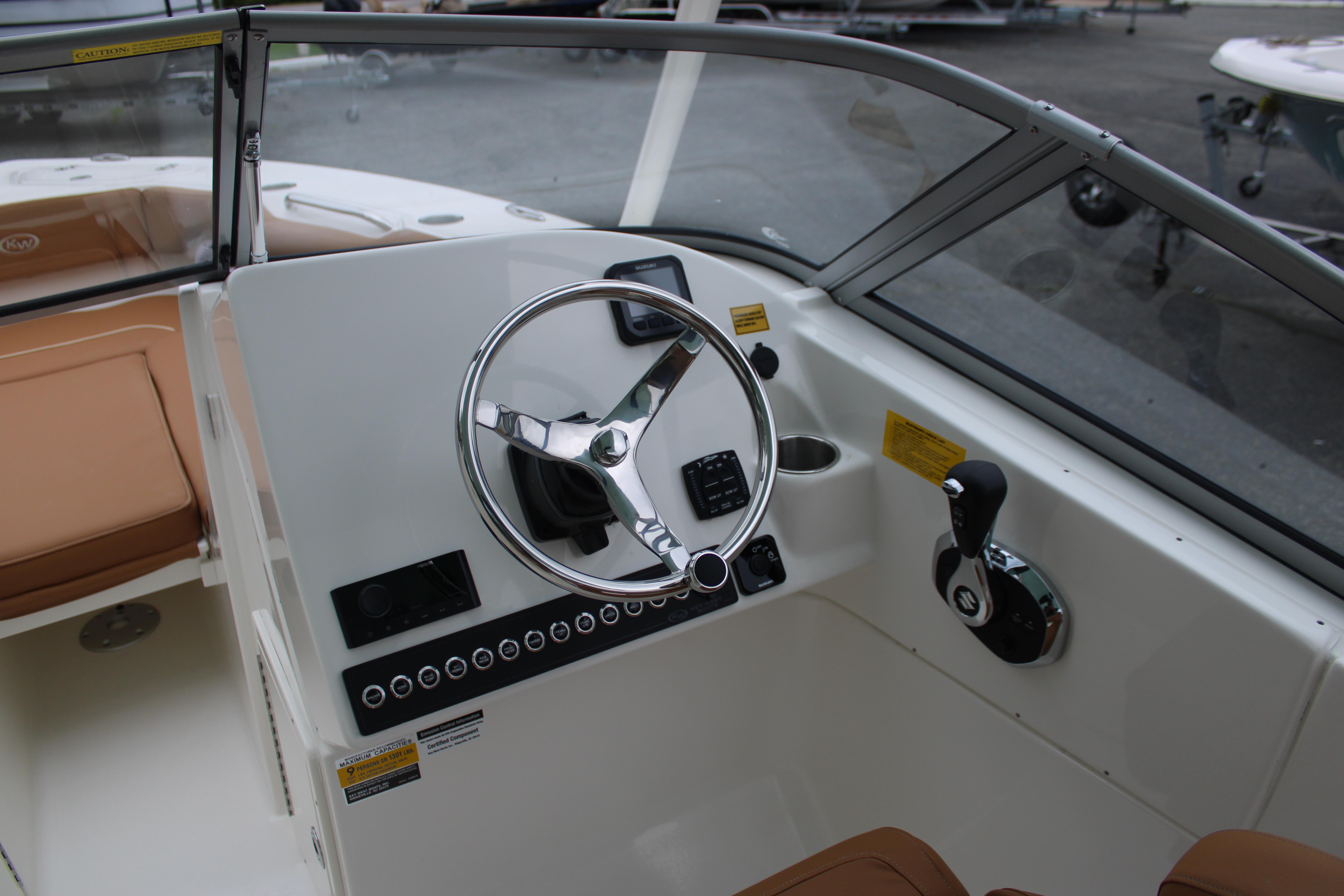Slide: The Image of 2026 Key West 239 DFS boat cockpit with steering wheel and controls. - 11