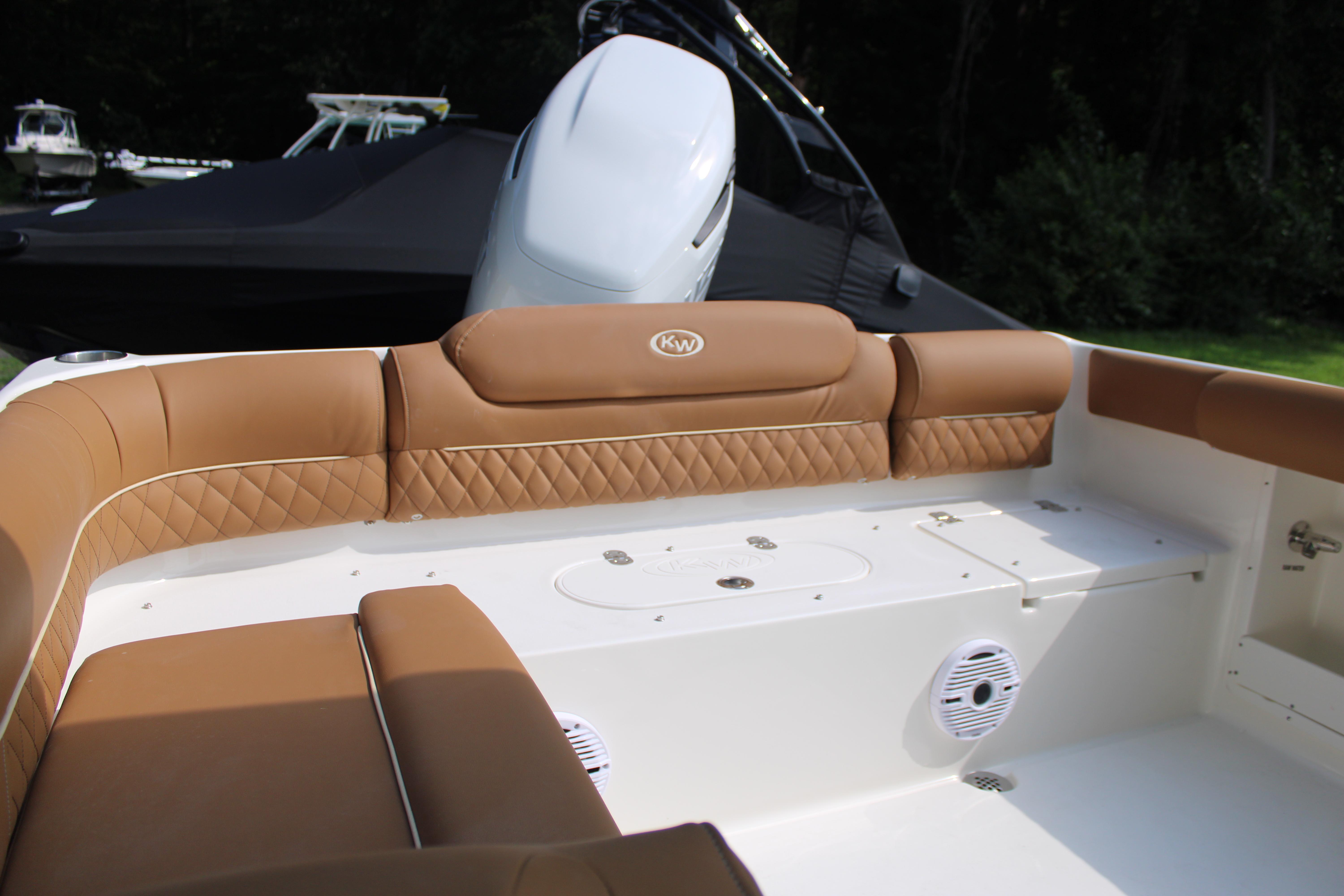 Slide: The Image of 2026 Key West 239 DFS boat interior with tan quilted seating and white deck. - 14