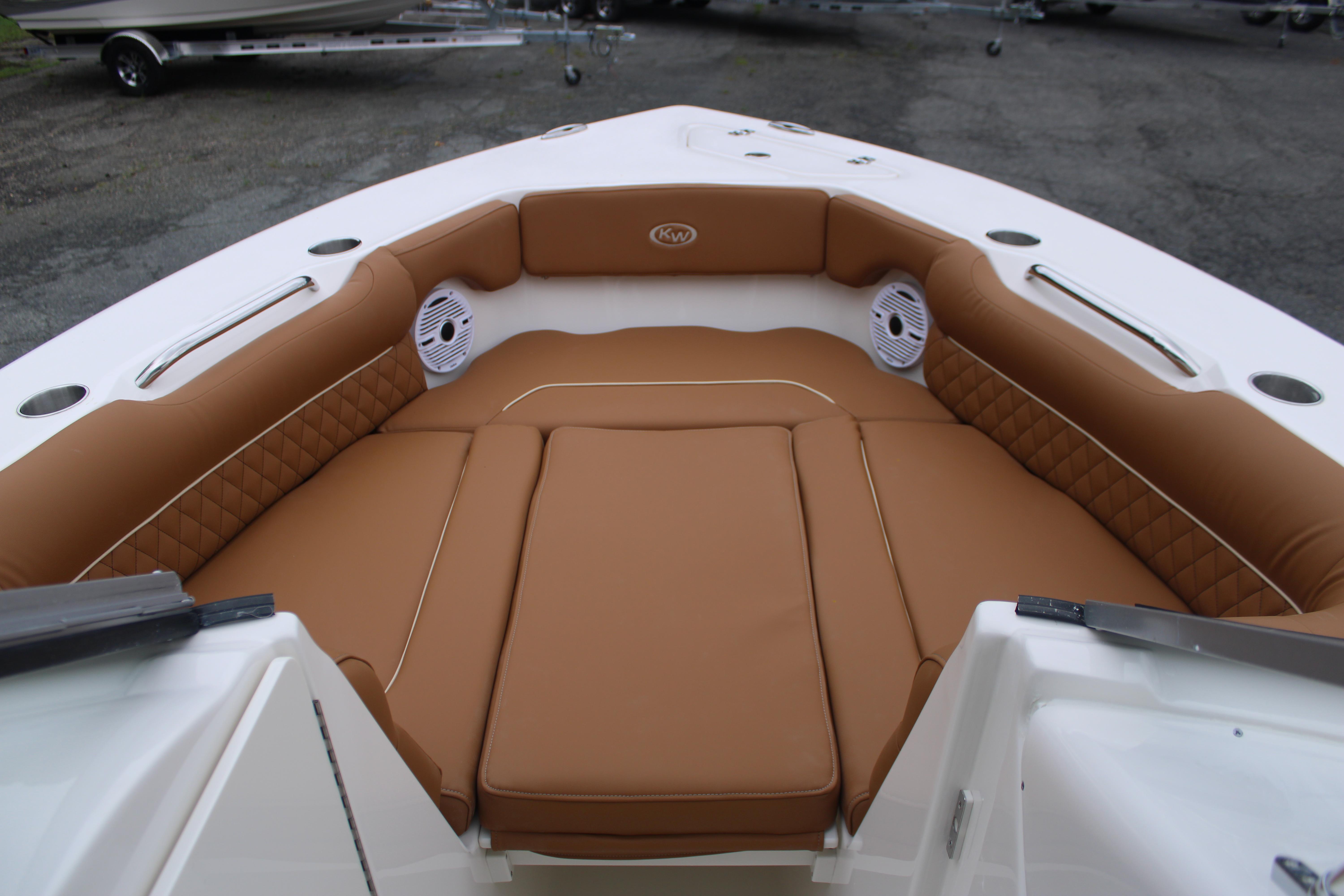 Slide: The Image of 2026 Key West 239 DFS boat interior with brown cushioned seating and speakers. - 17