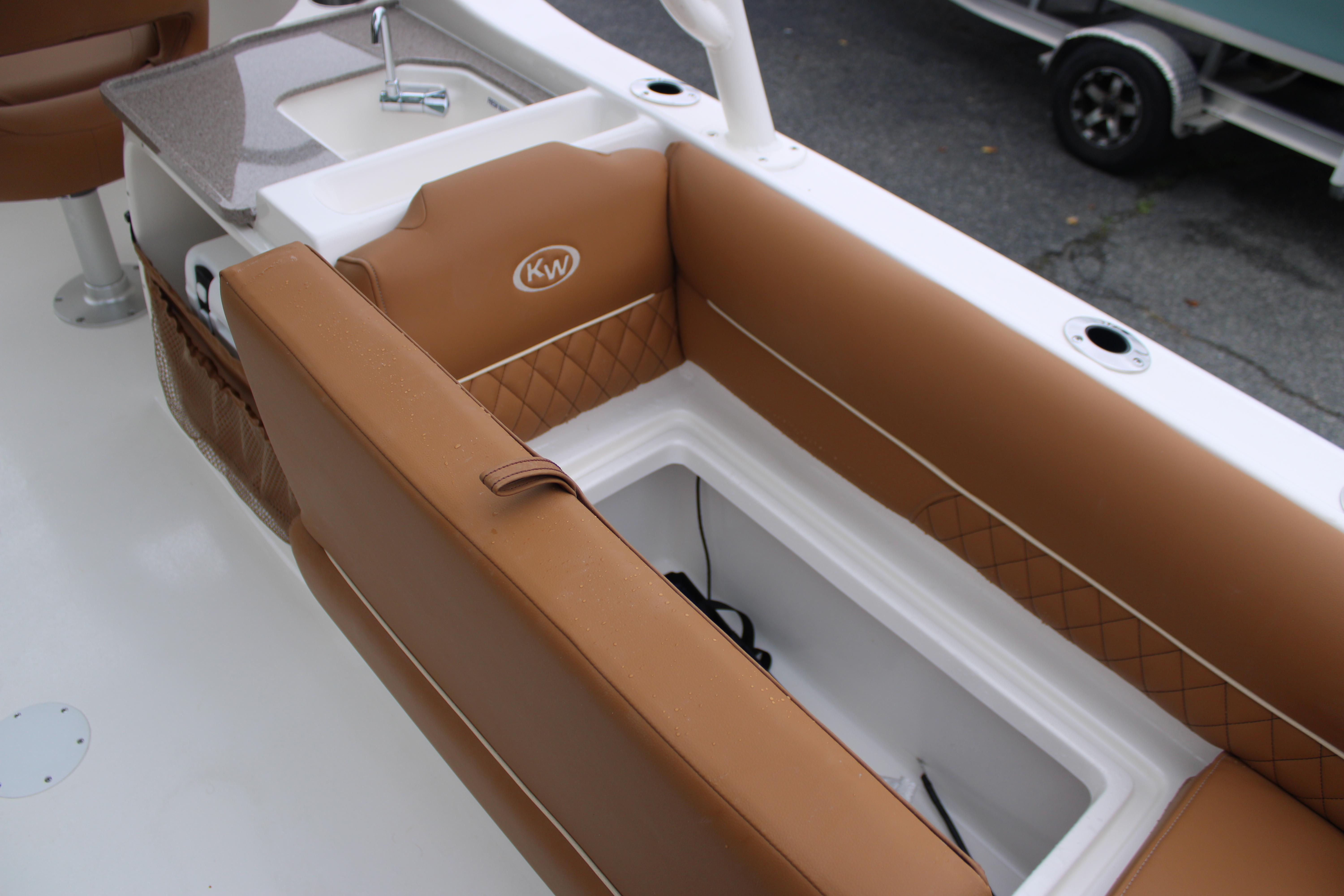Slide: The Image of 2026 Key West 239 DFS boat interior with tan seating and storage compartment. - 19