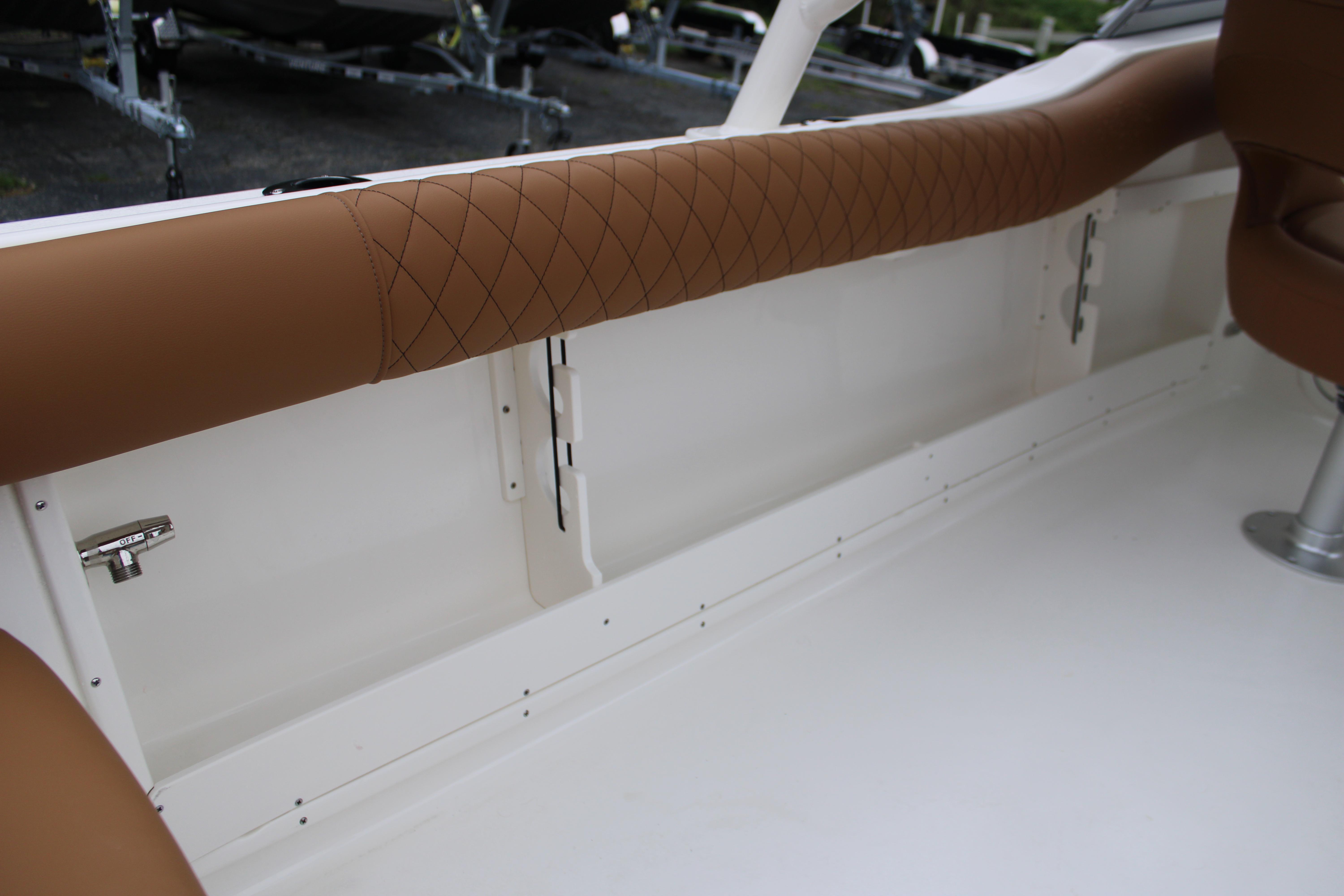 Slide: The Image of 2026 Key West 239 DFS boat interior with brown diamond-stitched upholstery and white deck. - 24