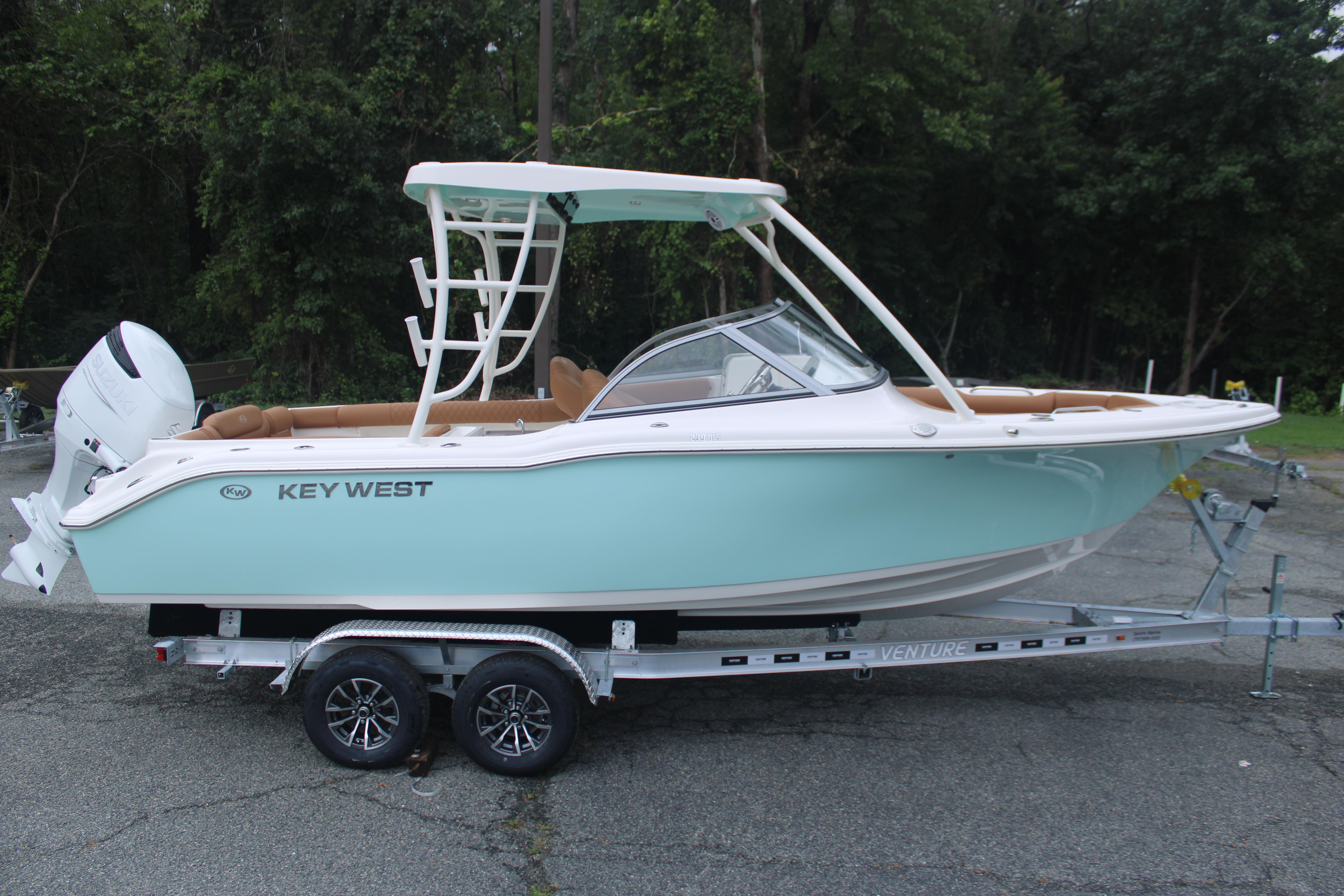 Slide: The Image of 2026 Key West 239 DFS boat on trailer, light blue hull, parked outdoors. - 4