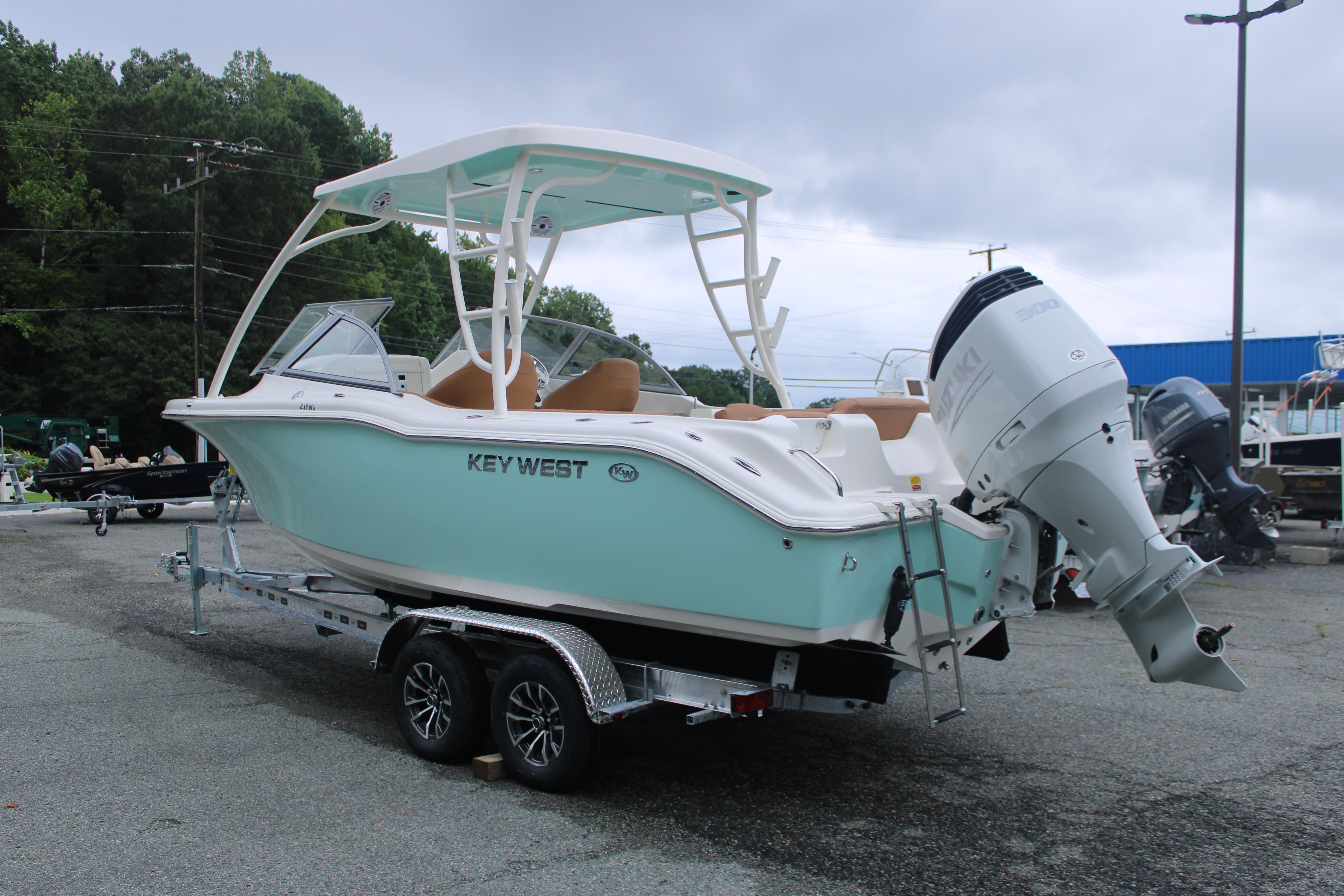 Slide: The Image of 2026 Key West 239 DFS boat on trailer, featuring sleek design and powerful outboard motor. - 7