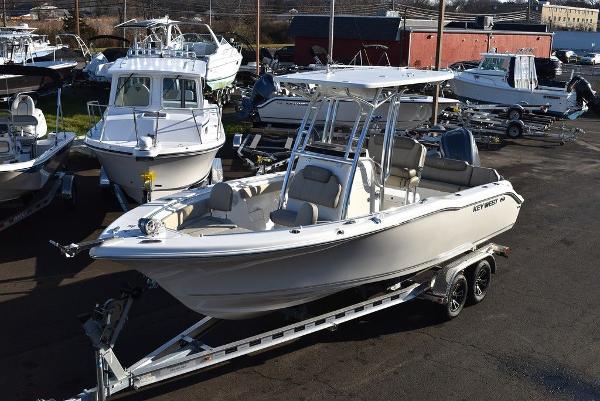 Slide: The Image of 2024 Key West 239 FS boat on trailer in marina setting. - 0