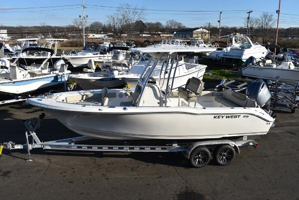 Slide: The Image of 2024 Key West 239 FS boat on trailer, surrounded by other boats in a marina. - 1