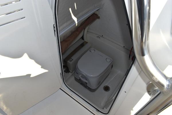 Slide: The Image of 2024 Key West 239 FS boat interior with compact marine toilet. - 18