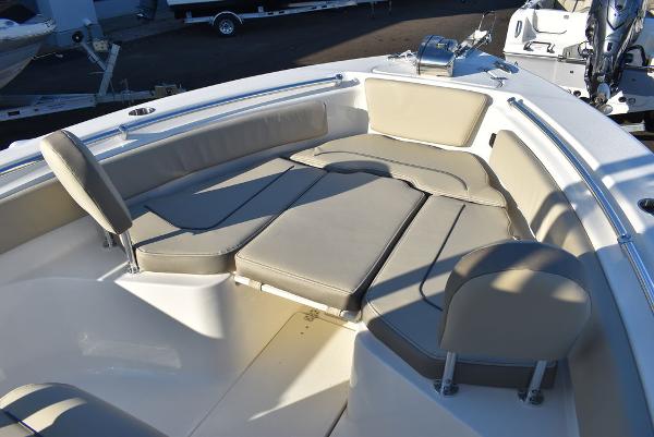 Slide: The Image of 2024 Key West 239 FS boat with cushioned seating in the bow area. - 24
