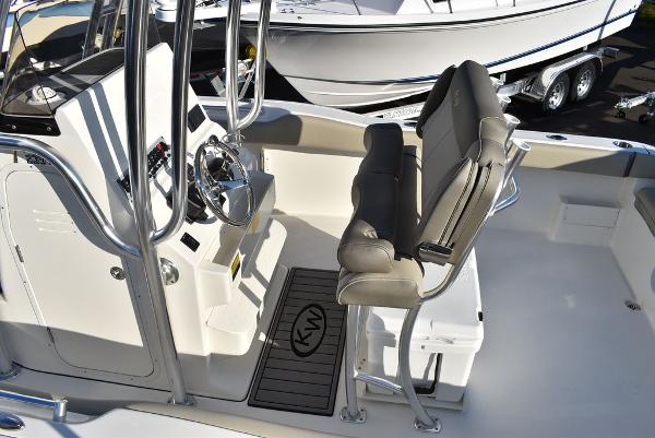 Slide: The Image of 2024 Key West 239 FS boat interior with helm and seating area. - 25