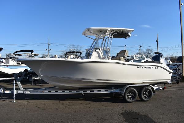 Slide: The Image of 2024 Key West 239 FS boat on trailer, side view, clear sky background. - 3