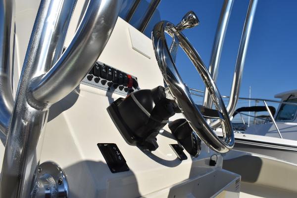 Slide: The Image of 2024 Key West 239 FS boat steering console with chrome details and controls. - 36