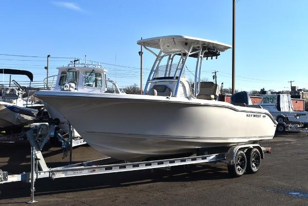 Slide: The Image of 2024 Key West 239 FS boat on trailer, displayed outdoors under clear sky. - 5