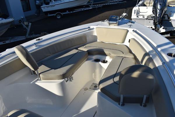 Slide: The Image of 2024 Key West 239 FS boat interior with cushioned seating and cup holders. - 7
