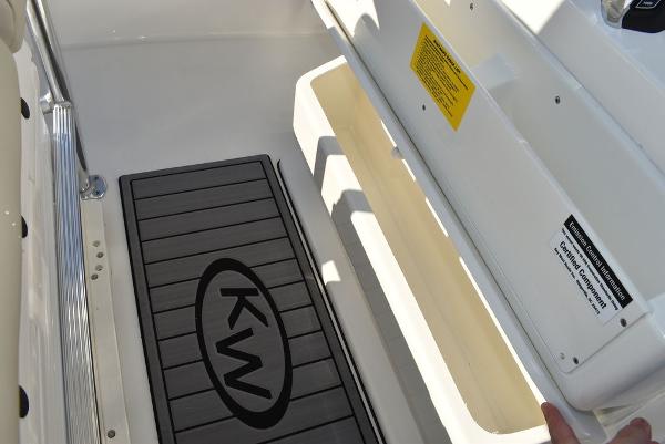 Slide: The Image of 2024 Key West 239 FS boat interior with KW logo mat and seating area. - 8