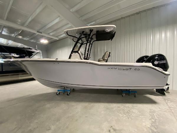 Slide: The Image of 2024 Key West 244 CC boat in a showroom, side view. - 0