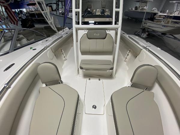 Slide: The Image of 2024 Key West 244 CC boat interior with beige seating and white accents. - 17