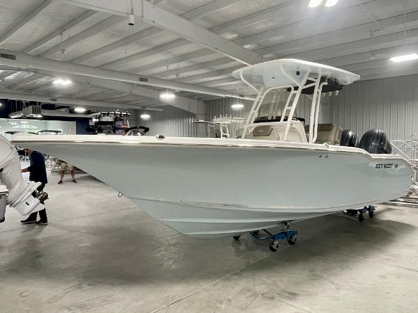 Slide: The Image of 2024 Key West 244 CC boat in showroom, side view. - 2