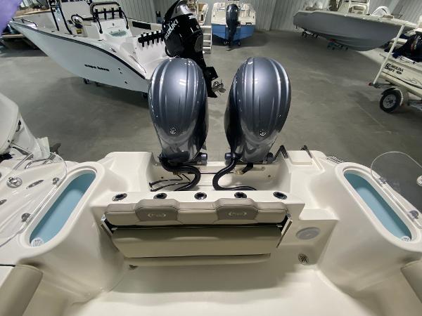 Slide: The Image of 2024 Key West 244 CC boat with dual outboard engines in a showroom. - 3