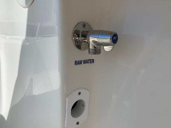 Slide: The Image of 2024 Key West 244 CC raw water outlet on white boat exterior - 33