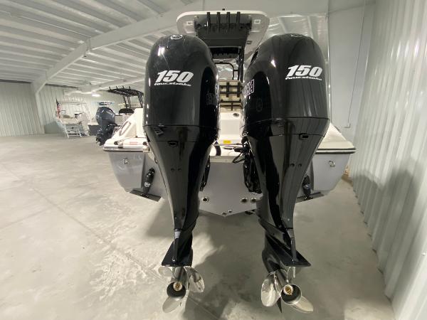 Slide: The Image of 2024 Key West 244 CC boat with twin 150 horsepower outboard engines in a storage facility. - 4