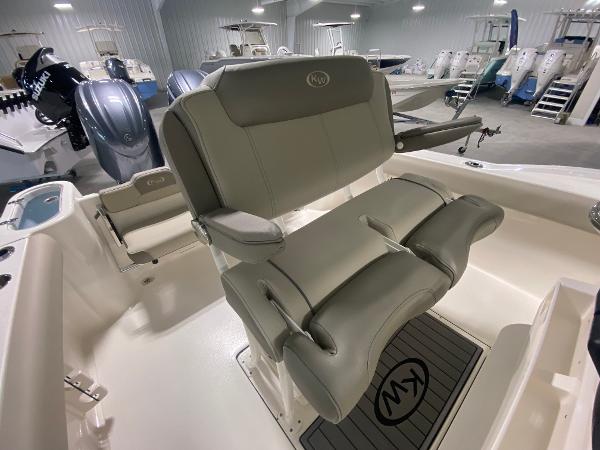 Slide: The Image of 2024 Key West 244 CC boat interior with cushioned seating and outboard motors. - 8