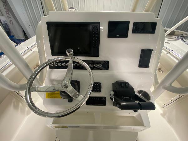 Slide: The Image of 2024 Key West 244 CC boat console with steering wheel and electronic controls. - 9