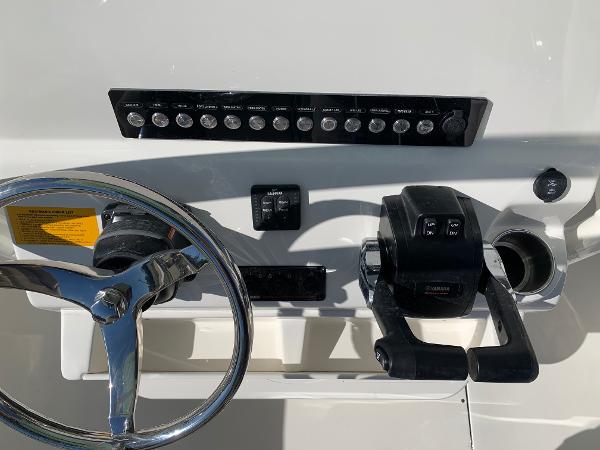Slide: The Image of 2024 Key West 244 CC boat dashboard with steering wheel and controls - 9