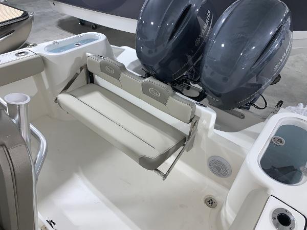 Slide: The Image of 2024 Key West 244 Center Console boat with dual outboard engines and foldable rear seat. - 15