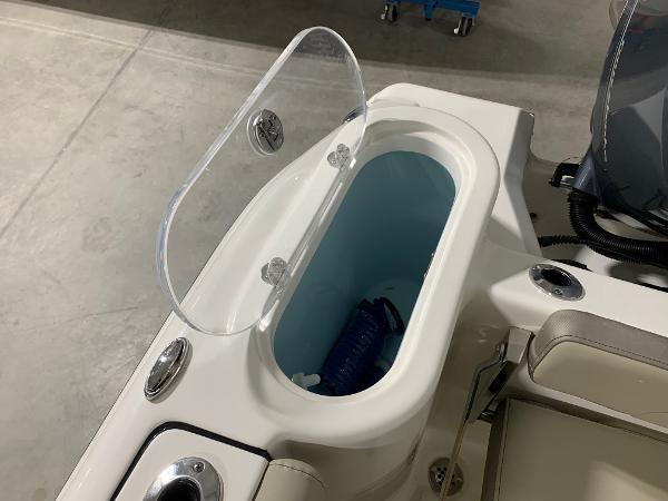 Slide: The Image of 2024 Key West 244 Center Console boat with open storage compartment. - 16