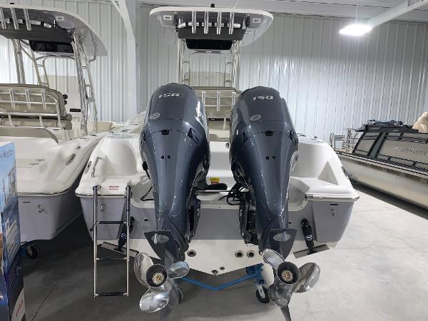 Slide: The Image of 2024 Key West 244 Center Console boat with twin 150 HP outboard engines in a showroom. - 3