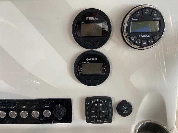 Slide: The Image of 2024 Key West 250 Bay Reef dashboard with Yamaha gauges and Clarion audio system. - 10