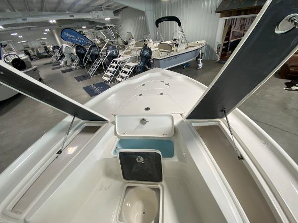 Slide: The Image of 2024 Key West 250 Bay Reef boat interior, showcasing storage compartments and seating. - 13