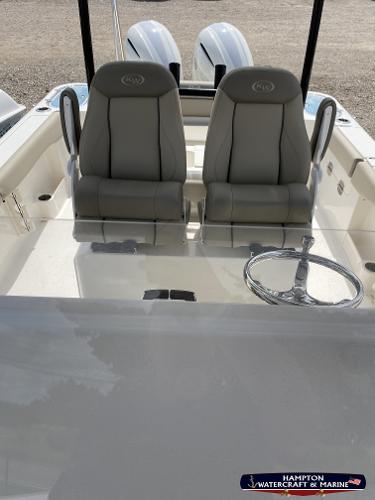 Slide: The Image of 2023 Key West 263 FS boat interior with dual captain's chairs and steering wheel. - 12