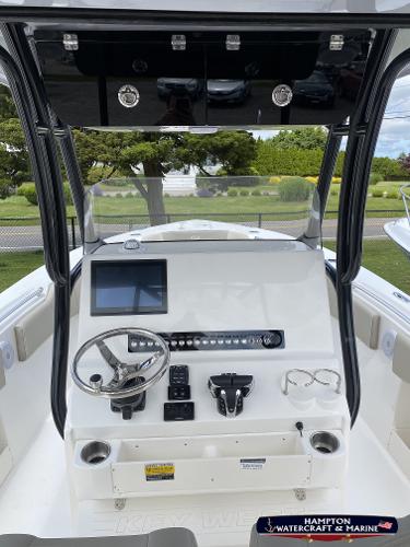 Slide: The Image of 2023 Key West 263 FS boat console with steering wheel and navigation screen. - 13