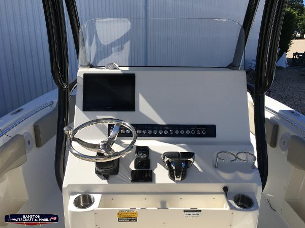 Slide: The Image of 2023 Key West 263 FS boat console with steering wheel, controls, and display screen. - 14