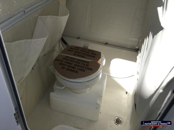 Slide: The Image of 2023 Key West 263 FS boat interior with a protected toilet. - 16