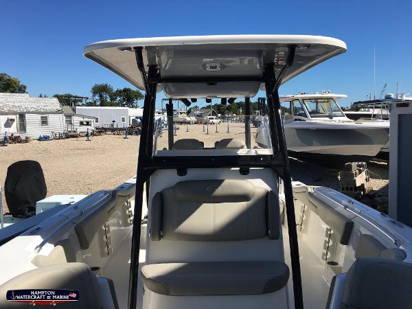 Slide: The Image of 2023 Key West 263 FS boat with seating and T-top in a marina. - 17