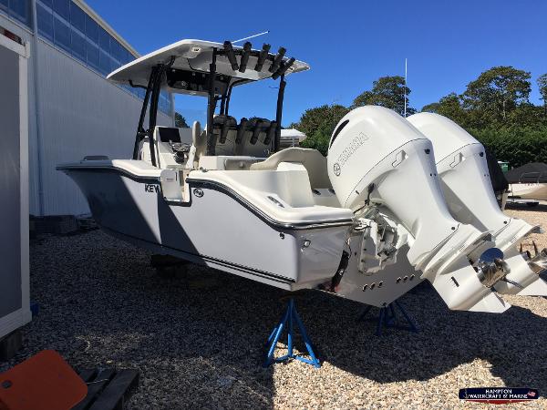 Slide: The Image of 2023 Key West 263 FS boat with dual outboard engines on stands. - 5