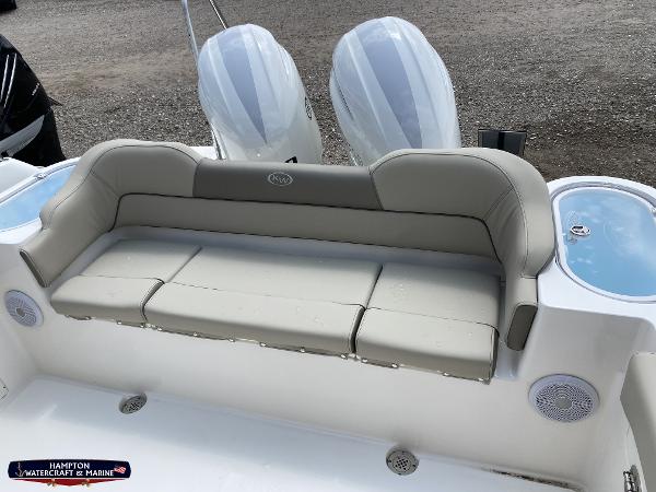 Slide: The Image of 2023 Key West 263 FS boat with cushioned seating and twin outboard motors. - 7