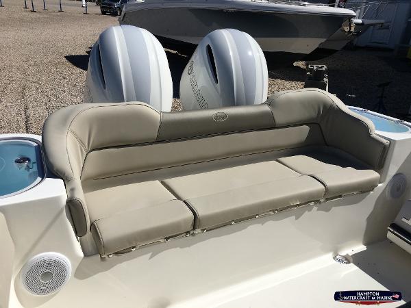 Slide: The Image of 2023 Key West 263 FS boat with beige cushioned seating and twin outboard motors. - 8