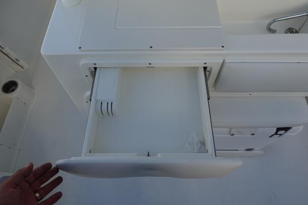 Slide: The Image of Open storage compartment on a 2024 Key West 263 FS boat. - 13