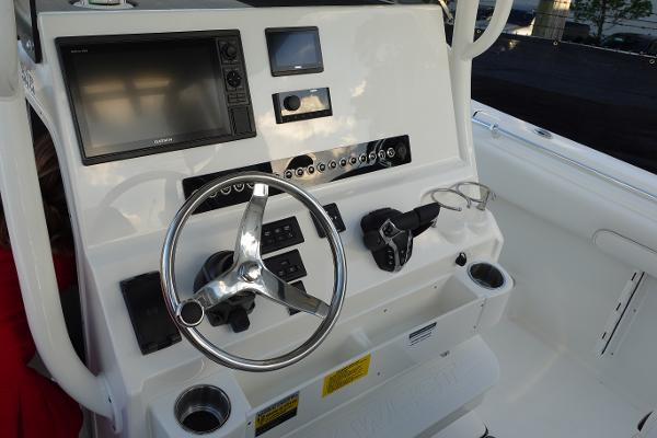 Slide: The Image of 2024 Key West 263 FS boat console with steering wheel and navigation controls. - 16