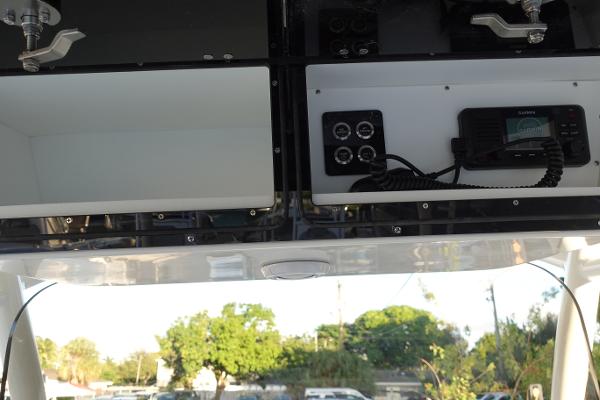 Slide: The Image of 2024 Key West 263 FS boat console with storage compartments and marine radio. - 18