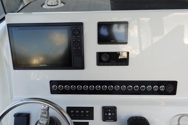 Slide: The Image of 2024 Key West 263 FS boat dashboard with Garmin navigation system and control panel. - 19