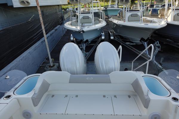 Slide: The Image of 2024 Key West 263 FS boat with dual outboard engines in a marina. - 41