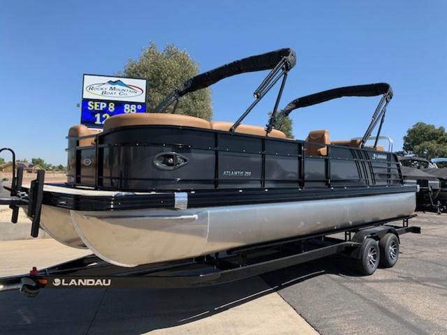 Slide: The Image of 2024 Landau Atlantis 250 Swingback Rear Lounge Tri-Log pontoon boat on trailer. - 1