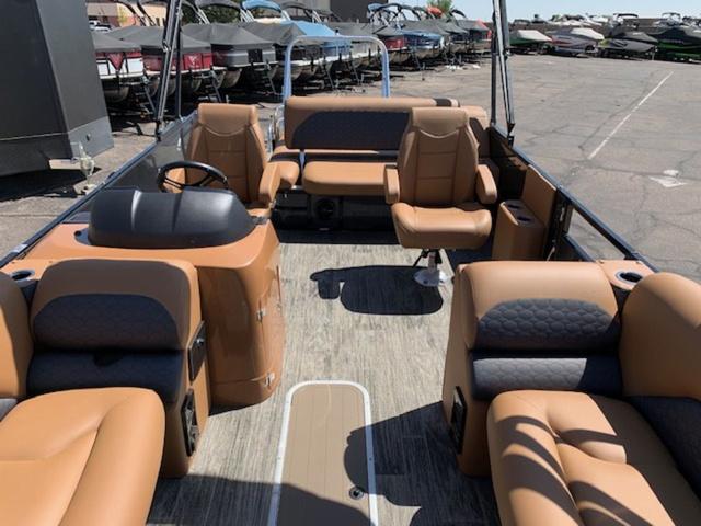 Slide: The Image of 2024 Landau Atlantis 250 Swingback Rear Lounge Tri-Log boat interior with tan and gray seating. - 11