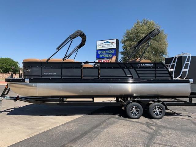 Slide: The Image of 2024 Landau Atlantis 250 Swingback Rear Lounge Tri-Log pontoon boat on trailer. - 2