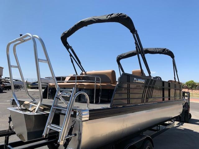 Slide: The Image of 2024 Landau Atlantis 250 Swingback Rear Lounge Tri-Log pontoon boat with dual bimini tops. - 5